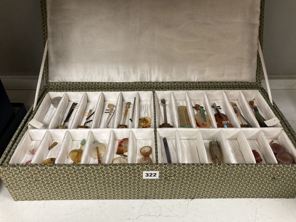 A collection of Chinese carved agate and other hardstone models of miniature musical instruments, together with hardwood stands, boxed